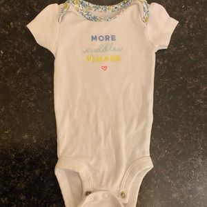 White, Blue, Yellow, and Pink Carters “More cuddles” newborn onesie